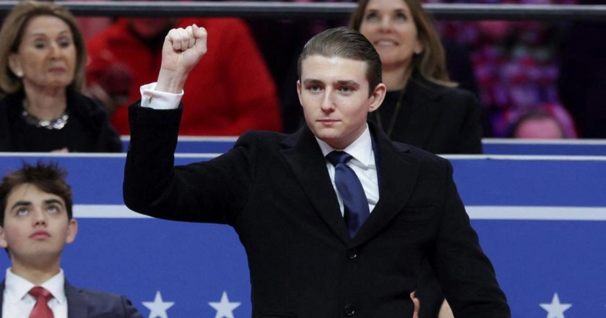 Barron Trump with his fist raised up at President Donald Trump's Inaugural Event