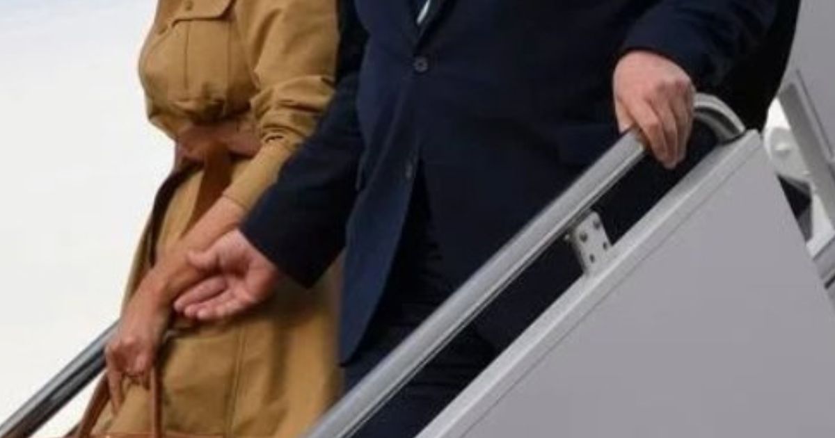 Donald Trump trying to hold Melania's hand