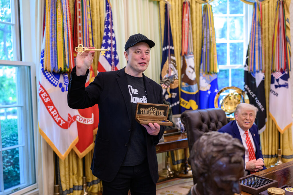 Donald Trump presenting Elon Musk with a gold key to the White House for his service (Image Source: X/The White House)