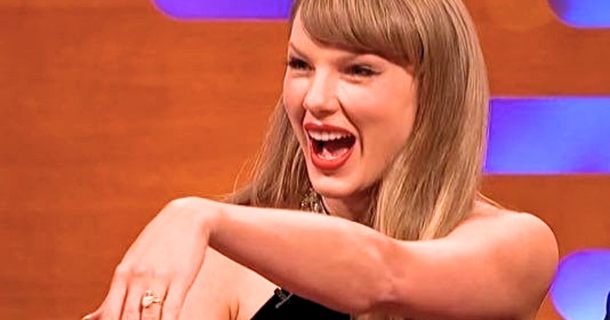 Taylor Swift showing her engagement ring while smiling on The Graham Norton Show